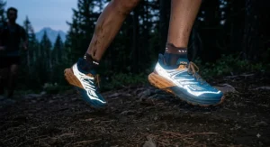 Reflective safety elements glowing on a pair of women's ultra marathon running shoes during a night run simulation.