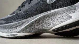 Close-up of stability running shoes for overpronation highlighting the reinforced arch support and midsole structure.