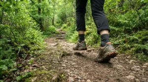 Hiker traversing a dirt path wearing durable running shoes for plantar fasciitis